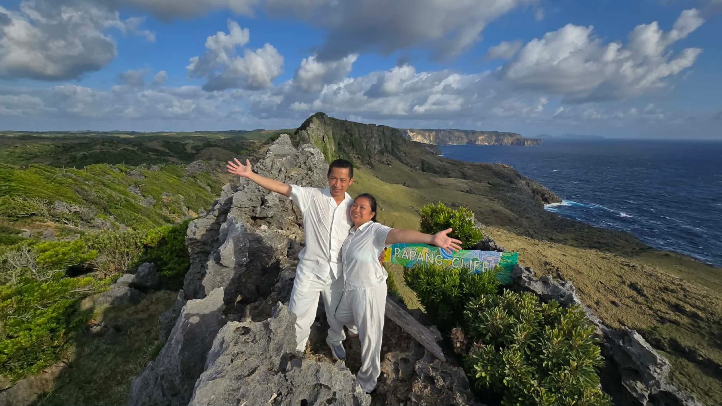Travelers experiencing the dramatic Rapang cliffs on Itbayat